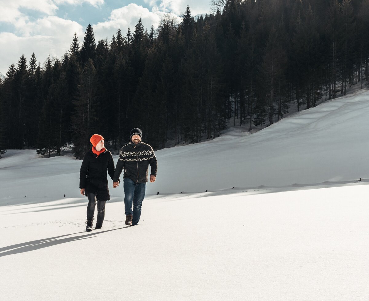 ein Paar spaziert in einer verschneiten Landschaft | © Urlaub am Bauernhof / Punkt und Komma