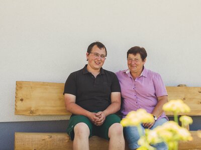 Karin and Matthias Pöllmann are sitting on the house bench. | © Farmholidays in SalzburgerLand / Matthias Gruber