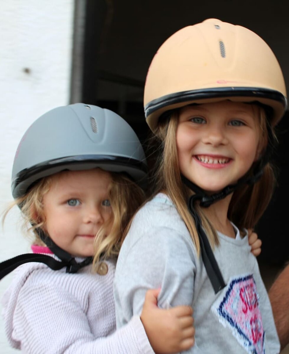 Kids with riding helmets