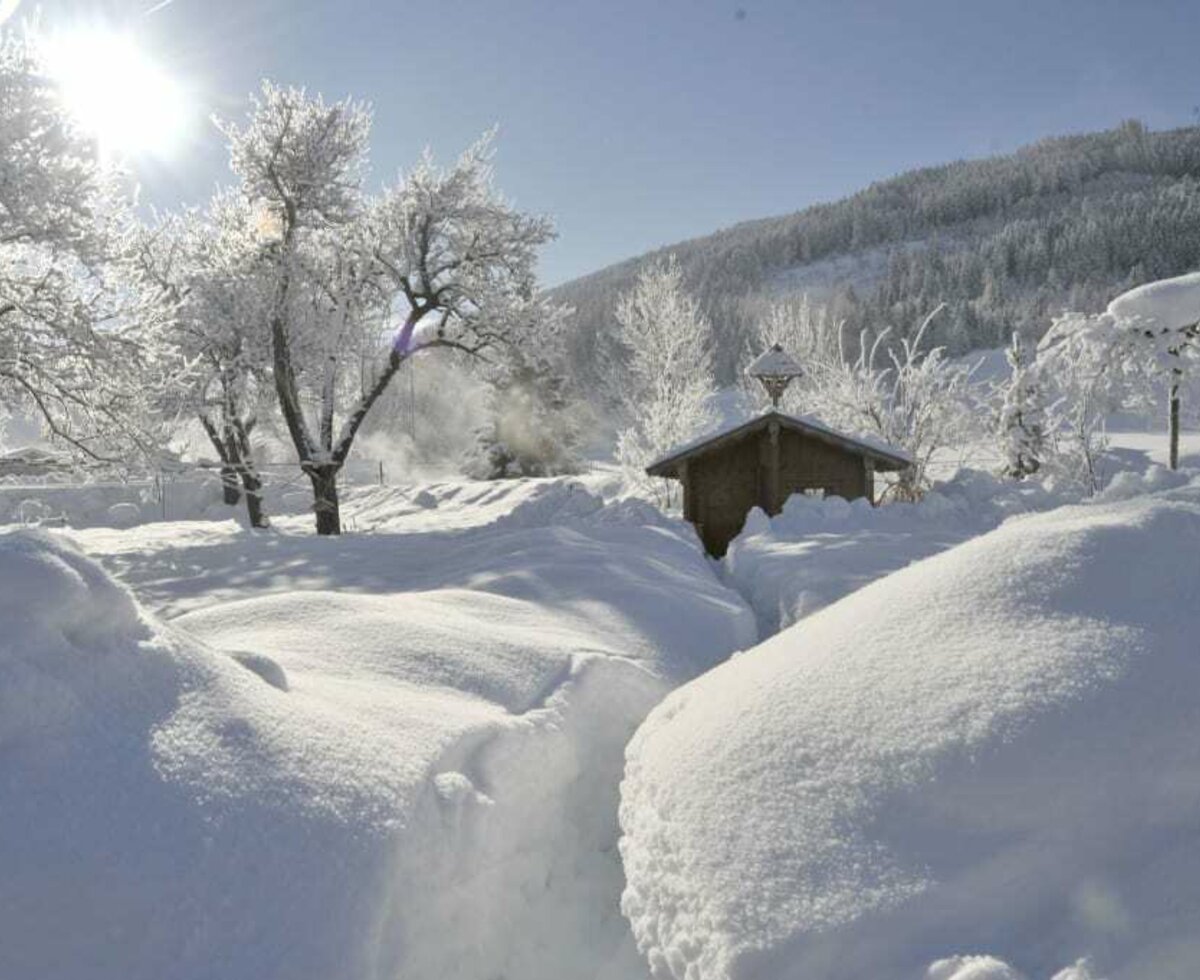 Children's playhouse covered in deep snow