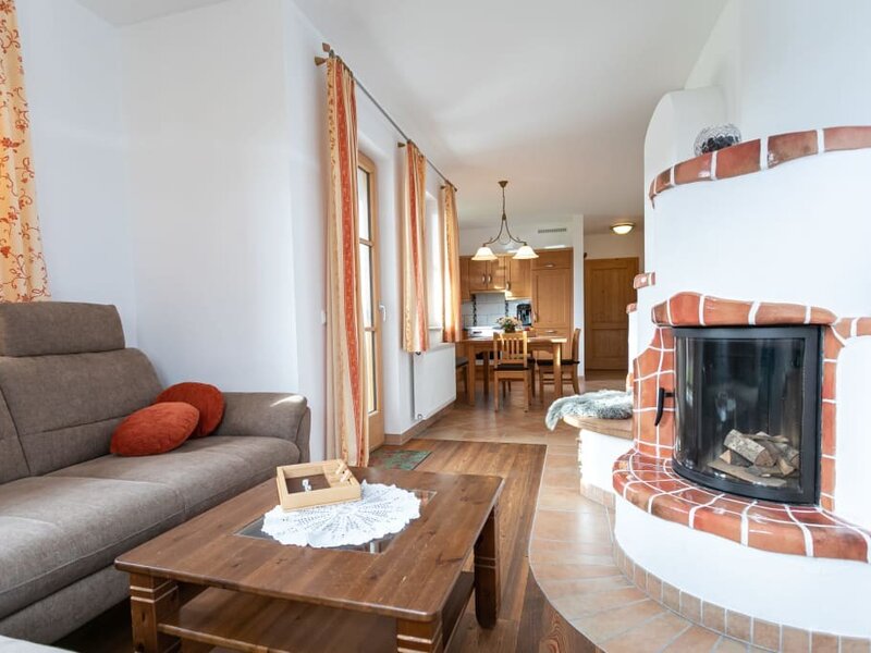 living area with chimney and new couch of the holiday apartment called Mohnblume (poppy flower)