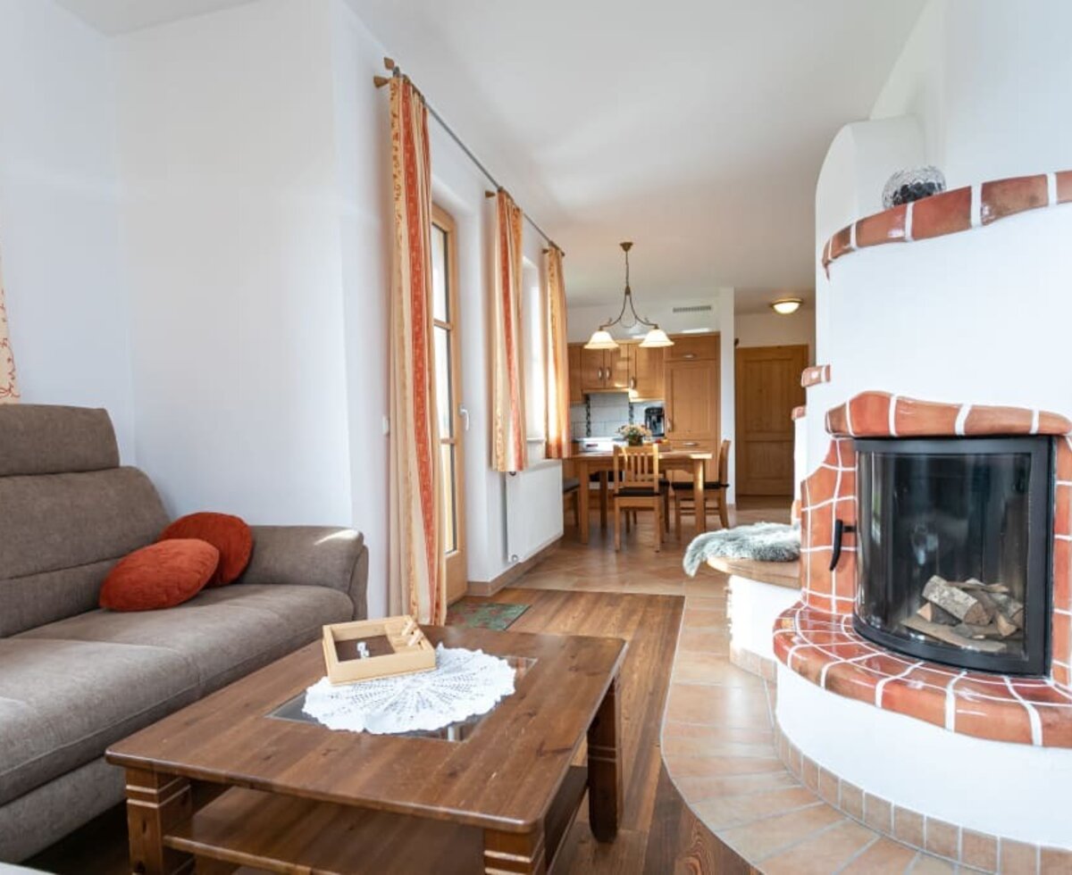 living area with chimney and new couch of the holiday apartment called Mohnblume (poppy flower)