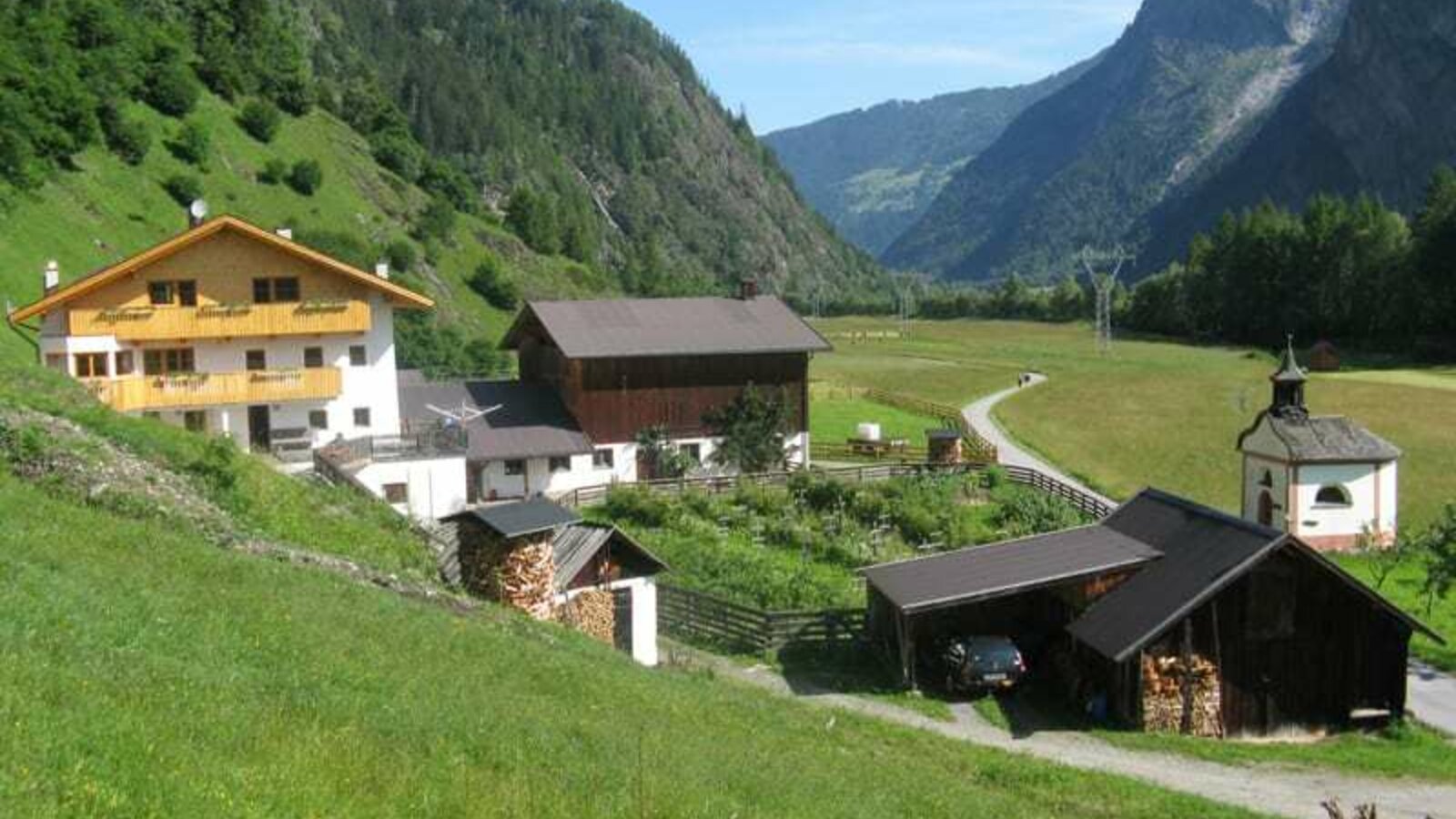 View from the south (an overall view of the farm): Smoke house, heated garage, private chapel, farm buildings, overlooking the valley and meadows in Umhausen and behind the ski and hiking area of Hochötz.