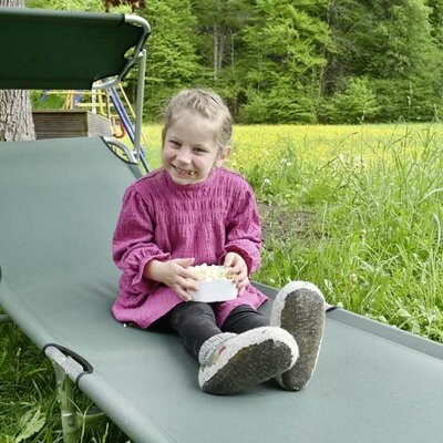 A child enjoys time on the lounger